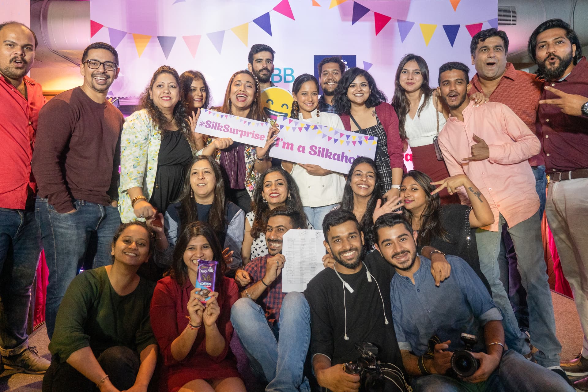 Crowd of attendees with #SilkSurprise signs at the Cadbury Silk Oreo Red Velvet launch.