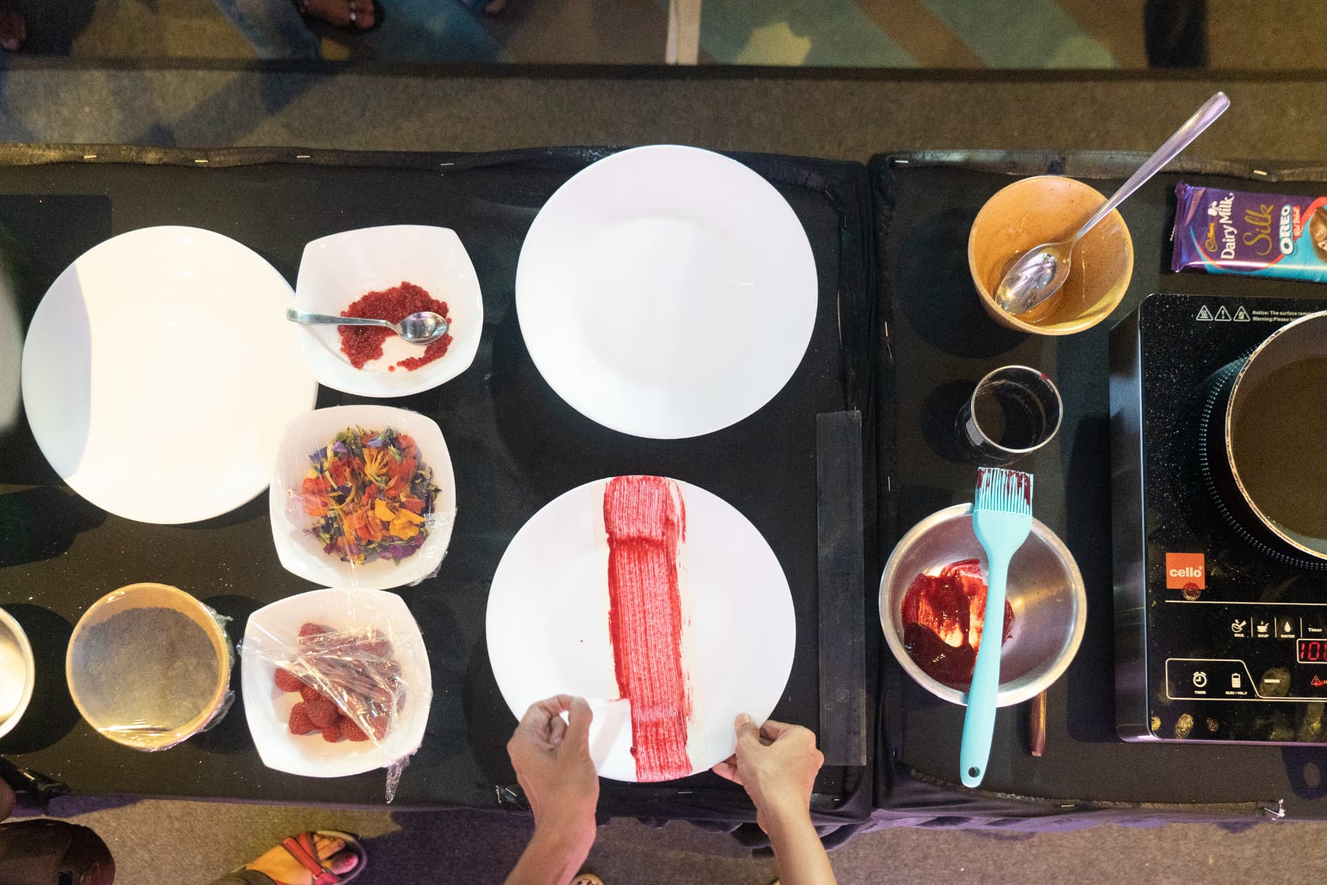 Overhead shot of a dessert plating demo at the Cadbury Silk Oreo Red Velvet launch.